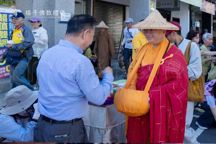 佛光山住持心保和尚手捧重缽受供，目光柔和慈憫專注於當下步伐，體現「上乞佛法，下化眾生」的修持精神 。｜楊子佛教禮儀公司